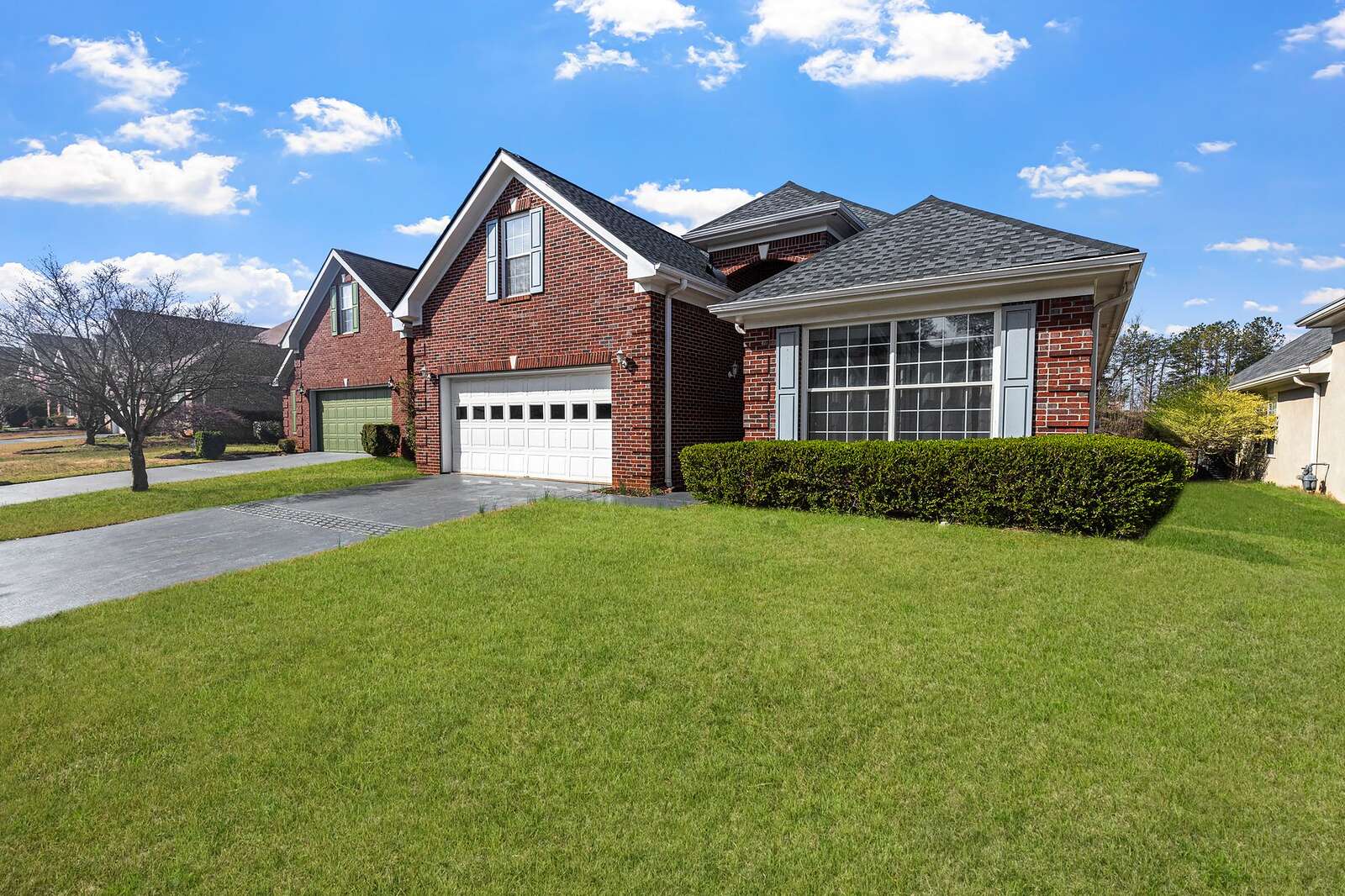 A mid-century brick ranch house with a low-pitched roof