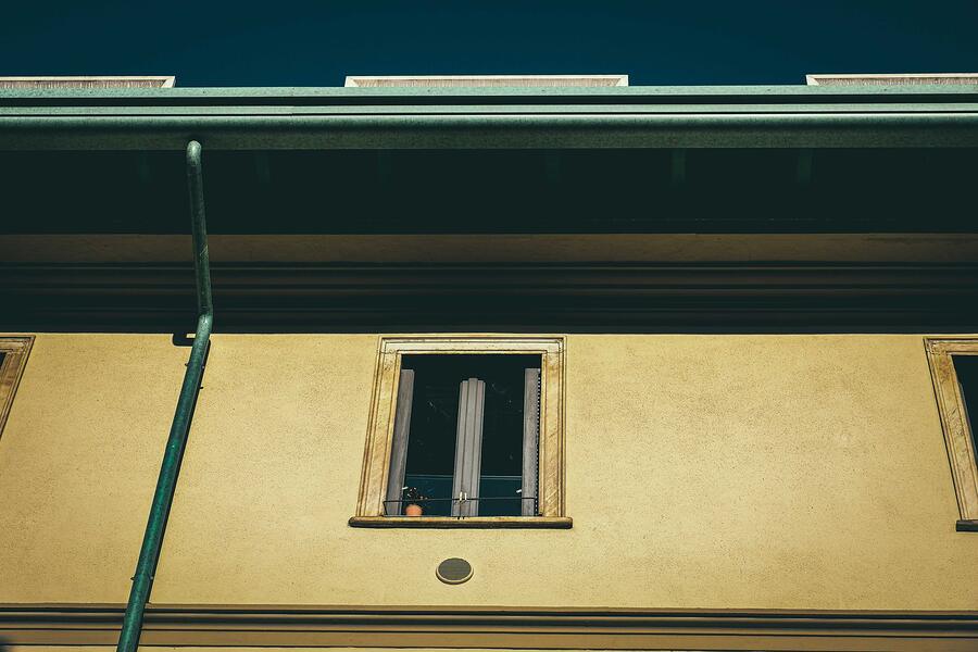The downspout and gutter line of a house from below