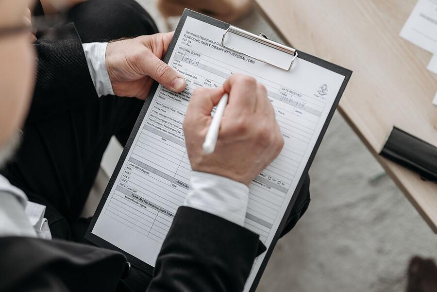 An inspection checklist being filled in on a clipboard