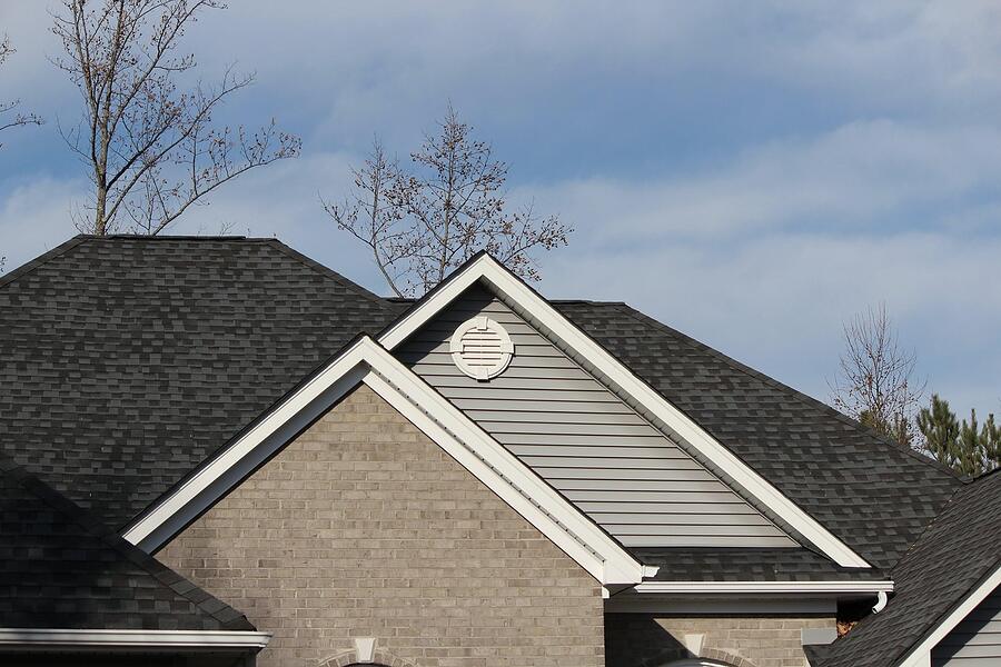 Composition shingle gables on a newer roof, with the vents and returns a rat uses