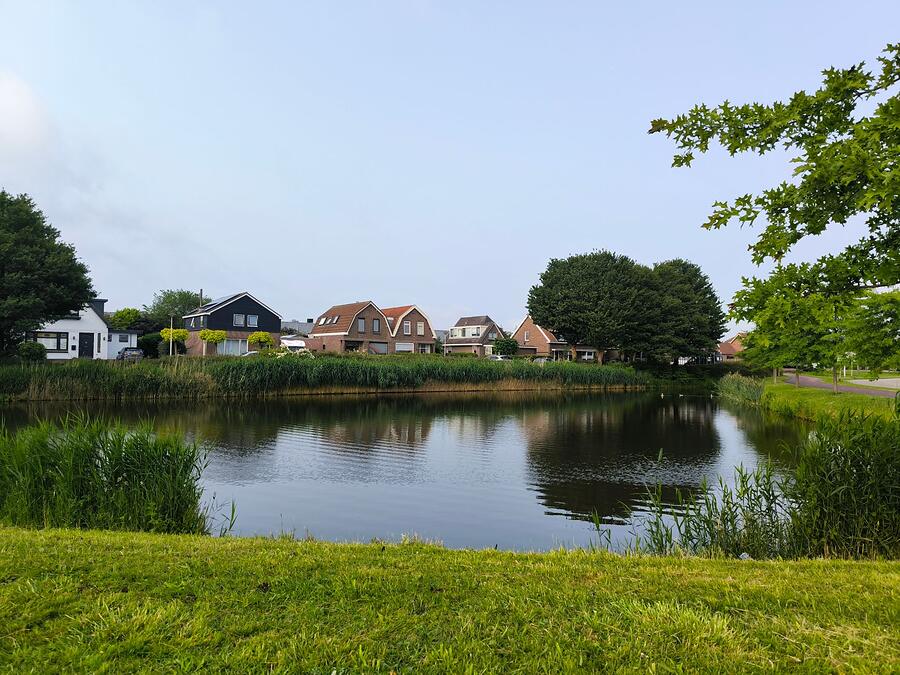 A detention pond with houses along the far bank